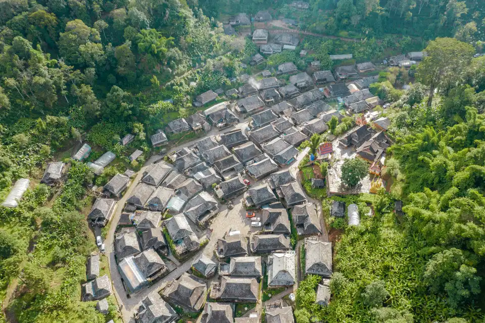 Notice a Dai village within the tea landscape