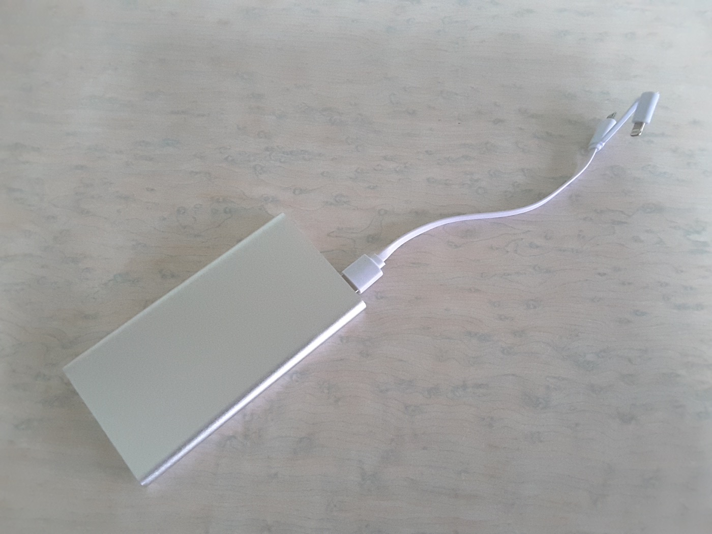 A portable USB power bank and charging cables